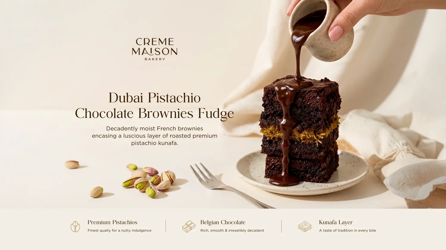 Hand pours glossy chocolate fudge over a three-layer pistachio brownie on a plate, brand Creme Maison Bakery visible in the background.